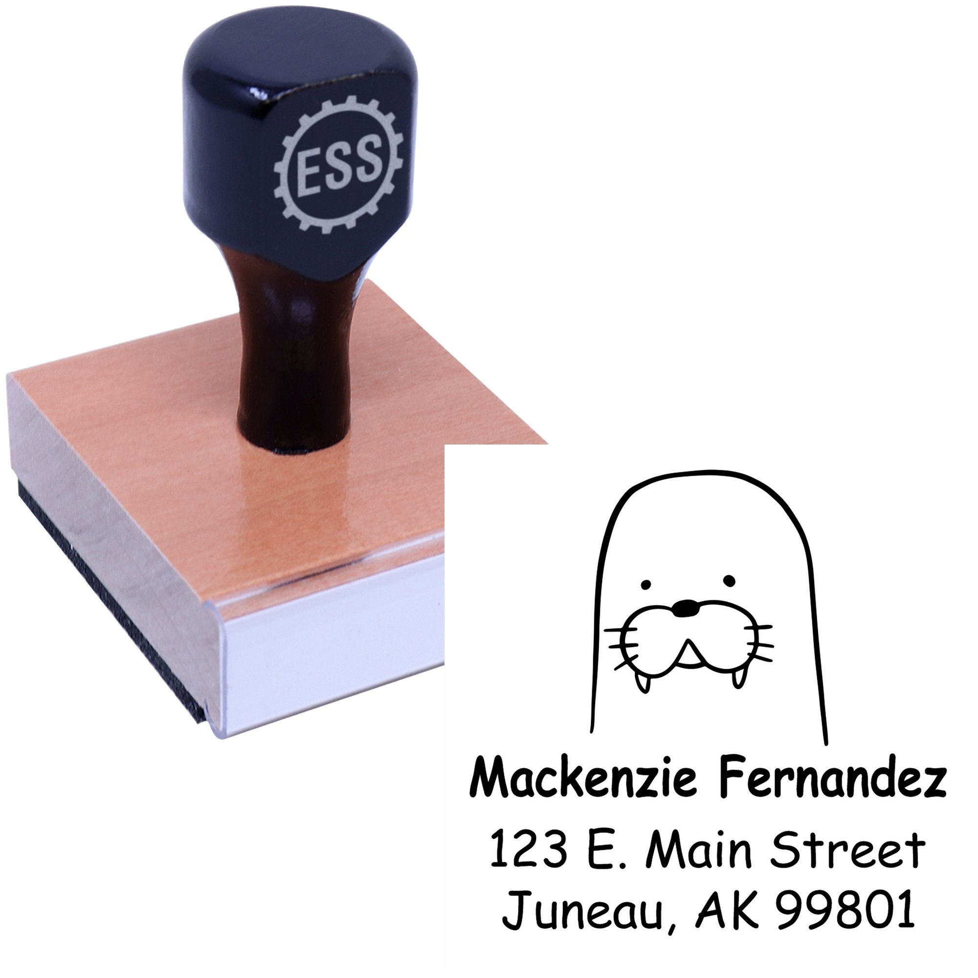 Wood handle stamp featuring a wacky walrus cartoon, labeled "ESS," with a personalized home address. The design reads "Mackenzie Fernandez, 123 E. Main Street, Juneau, AK 99801." Ideal for a made-to-order home address stamp or personalized mailing stamper.