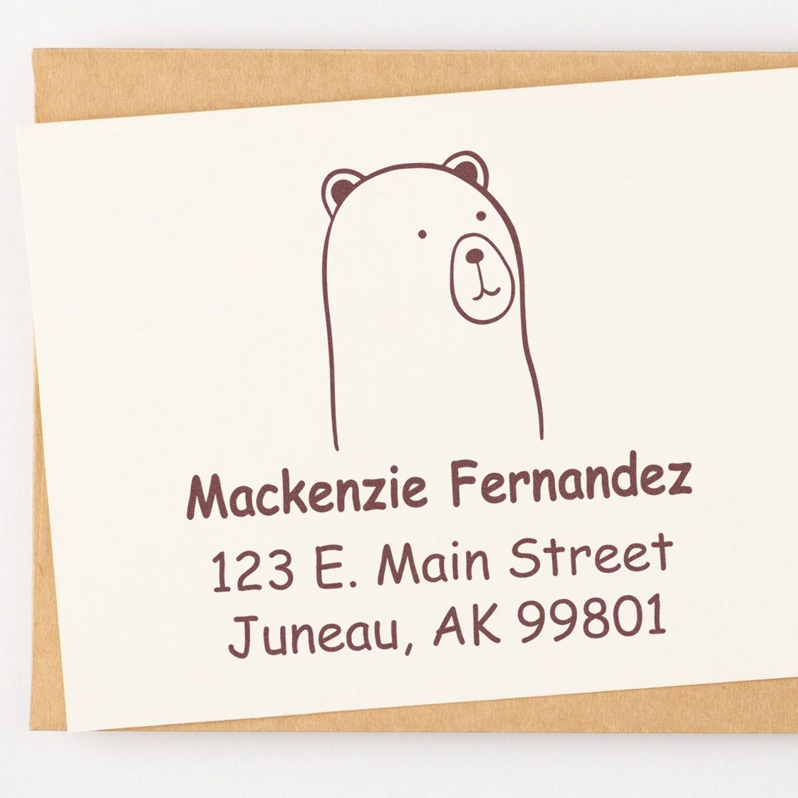 Portable Pre-Inked Cuddly Polar Bear Custom Designed Return Address Stamp on an envelope. The Personalizable Address Stamper features a cute bear illustration with the name Mackenzie Fernandez and address in Juneau, AK.