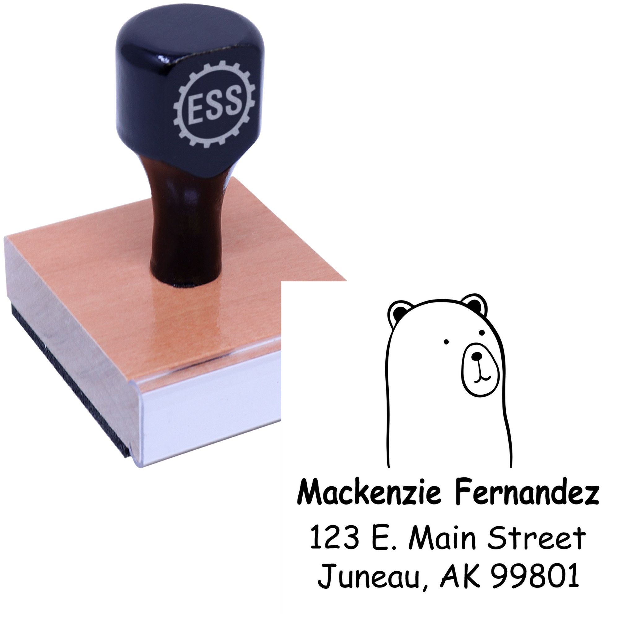 Wood handle stamper with a cuddly polar bear cartoon design, labeled "Made To Order New Home Stamper." Features personalized return mail stamper details for Mackenzie Fernandez, 123 E. Main Street, Juneau, AK 99801.
