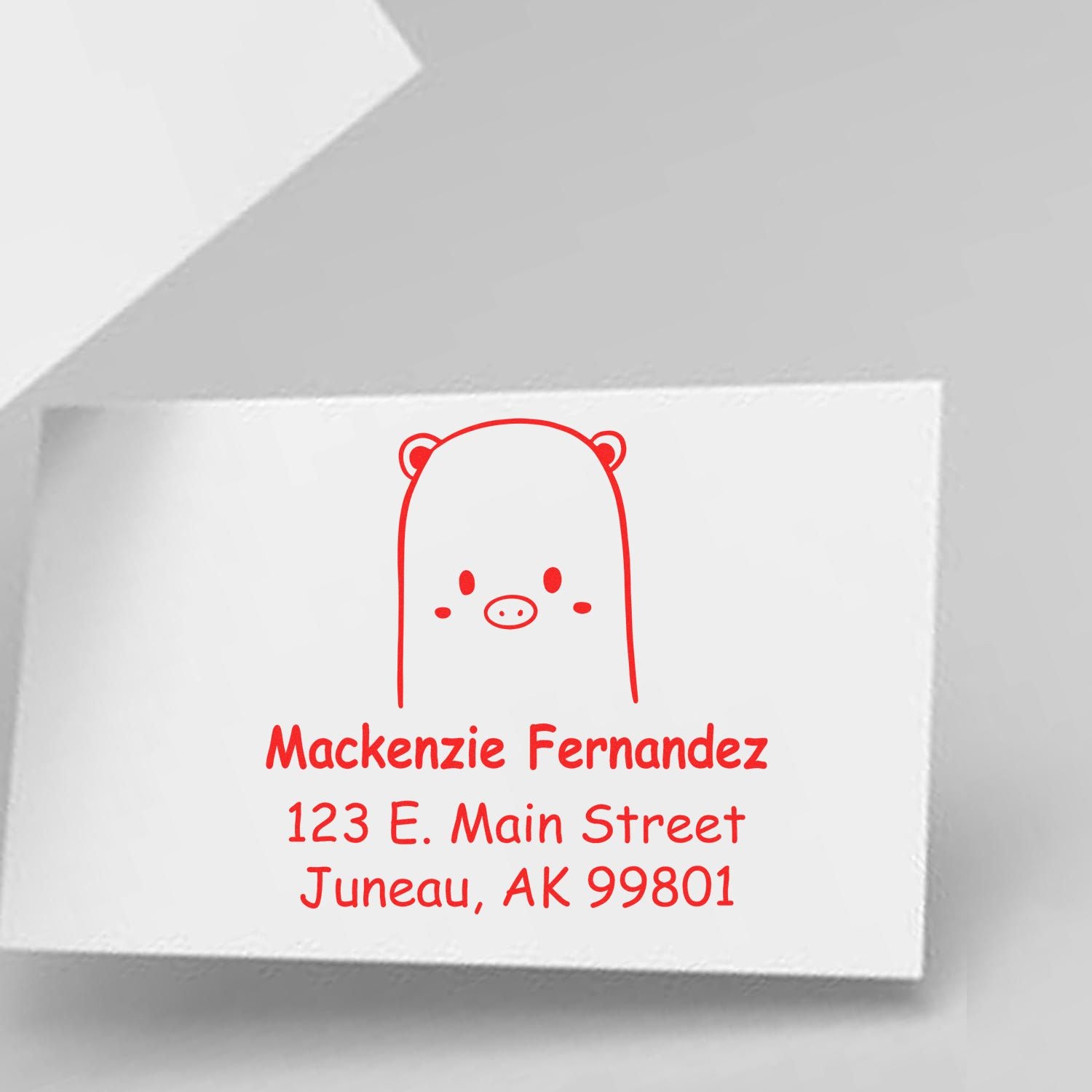 Portable Pre-Inked Beautiful Bear Made To Order Mail Stamper displayed on a white card. The Customized New Address Stamp features a cute bear design with red ink, showing the name "Mackenzie Fernandez" and an address in Juneau, AK.