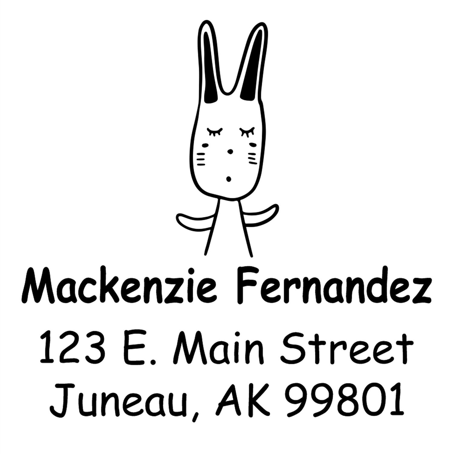 Wood Handle Hopping Bunny Cartoon Animal Custom Return Address Stamper featuring a cute bunny design. Personalizable Address Stamper with the name "Mackenzie Fernandez" and address "123 E. Main Street, Juneau, AK 99801" in bold, playful font.