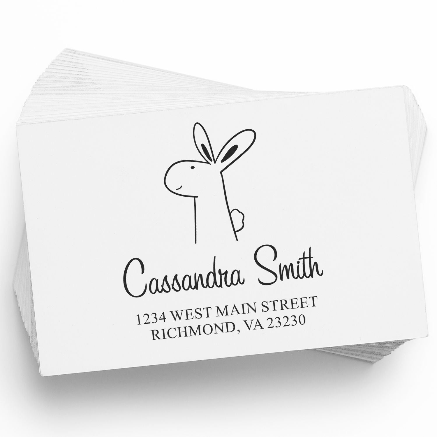Self-Inking Cartoon Animal Bouncy Bunny Personalized Home Address Stamper on a stack of cards. The design features a cute bunny illustration above the name "Cassandra Smith" and address, showcasing a Personalized Mailing Stamp for home use.