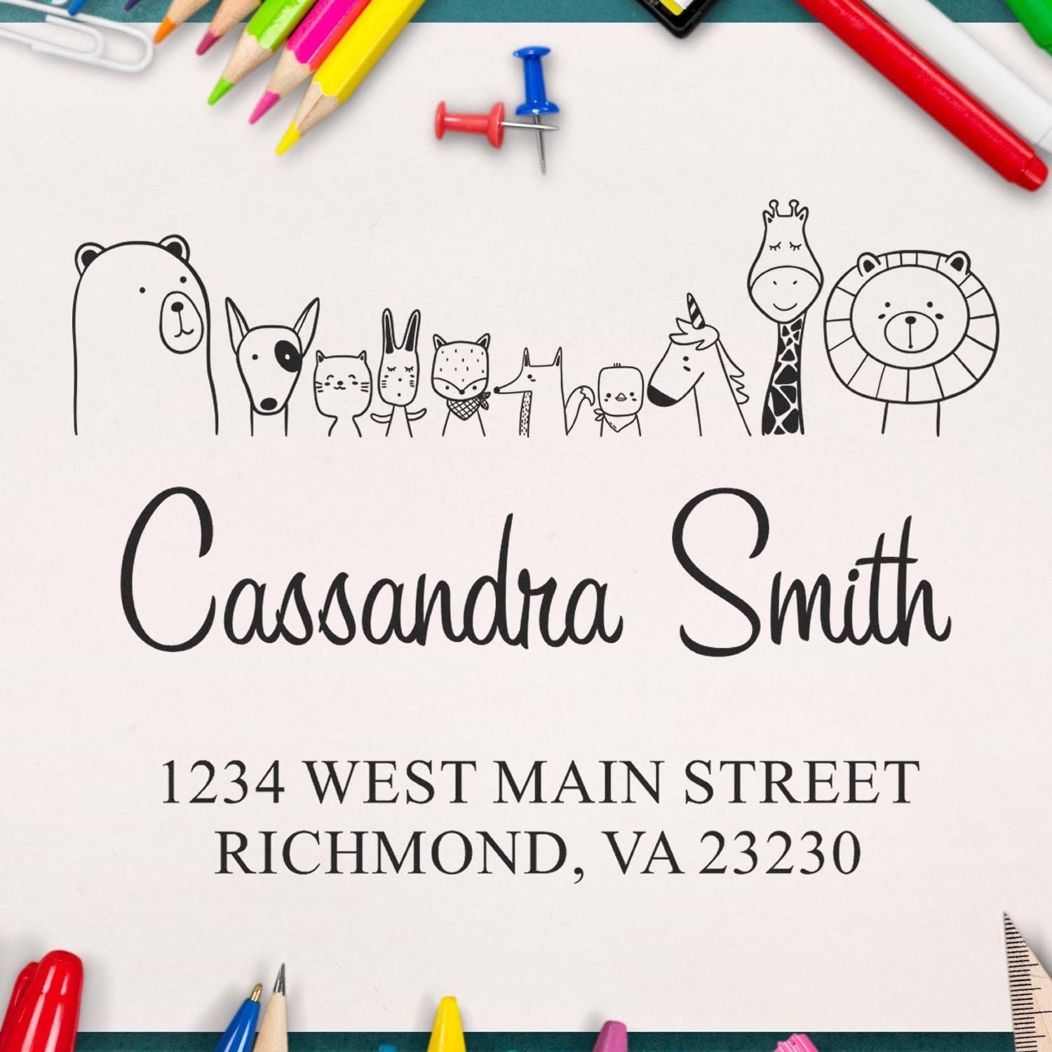 Wood Handle Zany Zoo Cartoon Animal Custom New Home Stamp displayed on paper with "Cassandra Smith" and address. Personalizable Address Stamp surrounded by colorful pencils and pushpins.