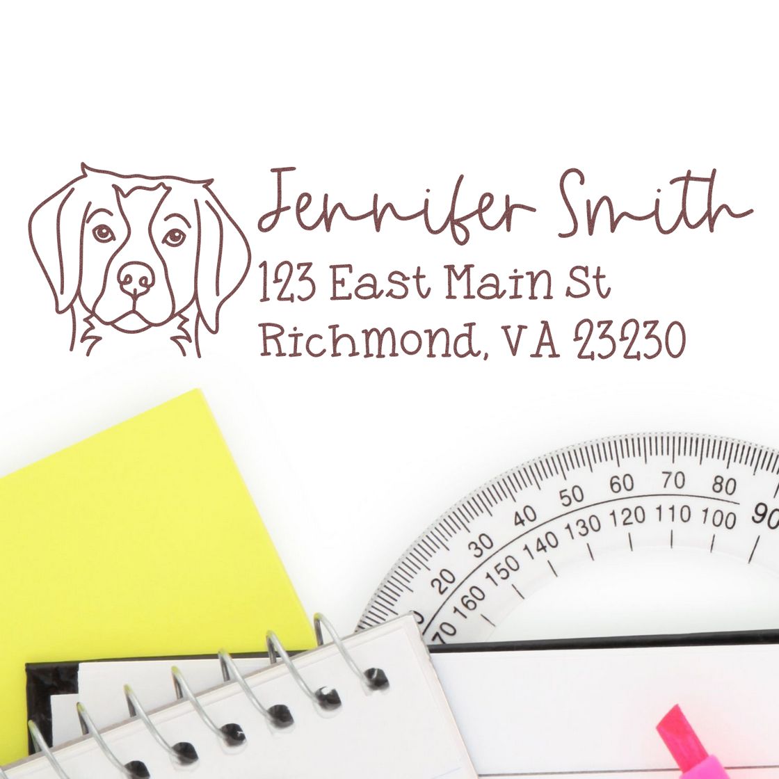 Brown custom dog address stamp and seal with Jennifer Smith, Richmond, VA on white, beside yellow paper, protractor and notebook.