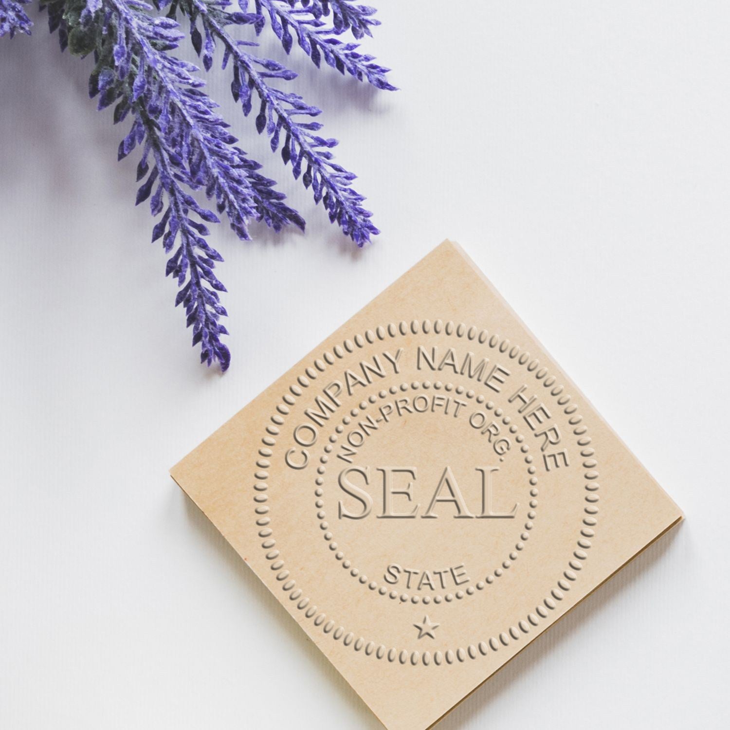 Beige embossed custom stamp and seal with dotted border, centered seal text, and purple lavender sprigs on a white background.