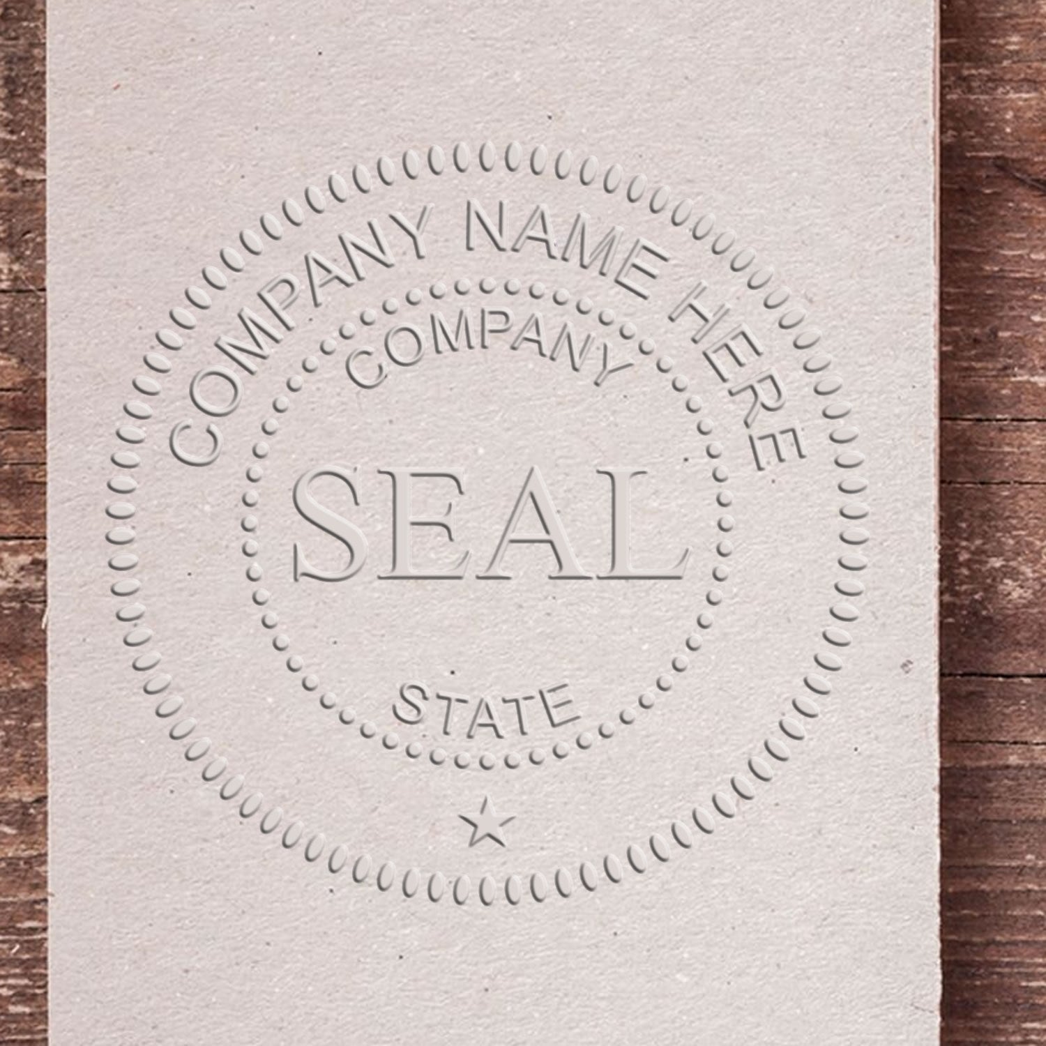 Custom embossed gray business seal stamp with dotted border, company name, state text, and star.