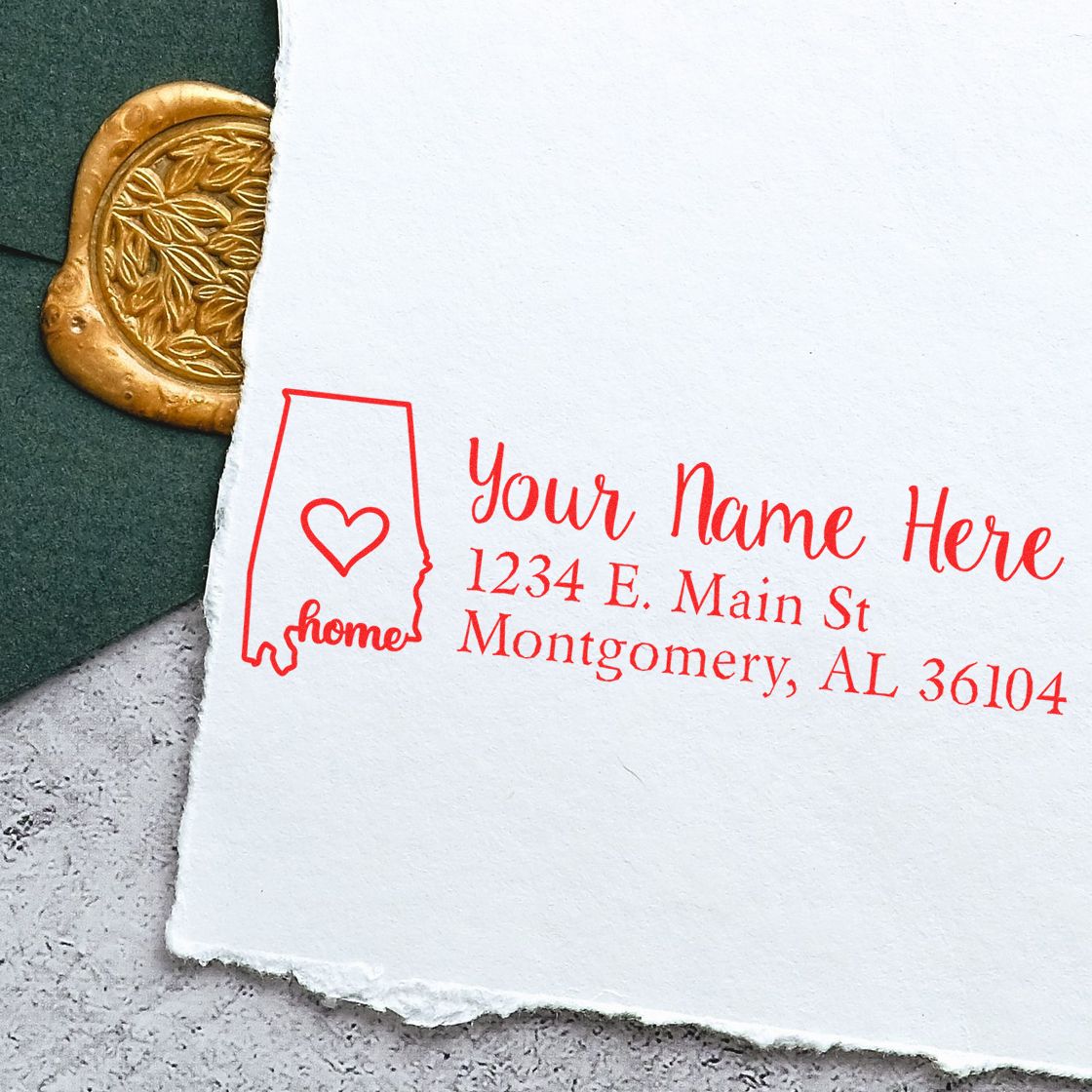Wood handle Alabama state rubber stamp from ESS, featuring custom address design, used for personalized return address stamping.