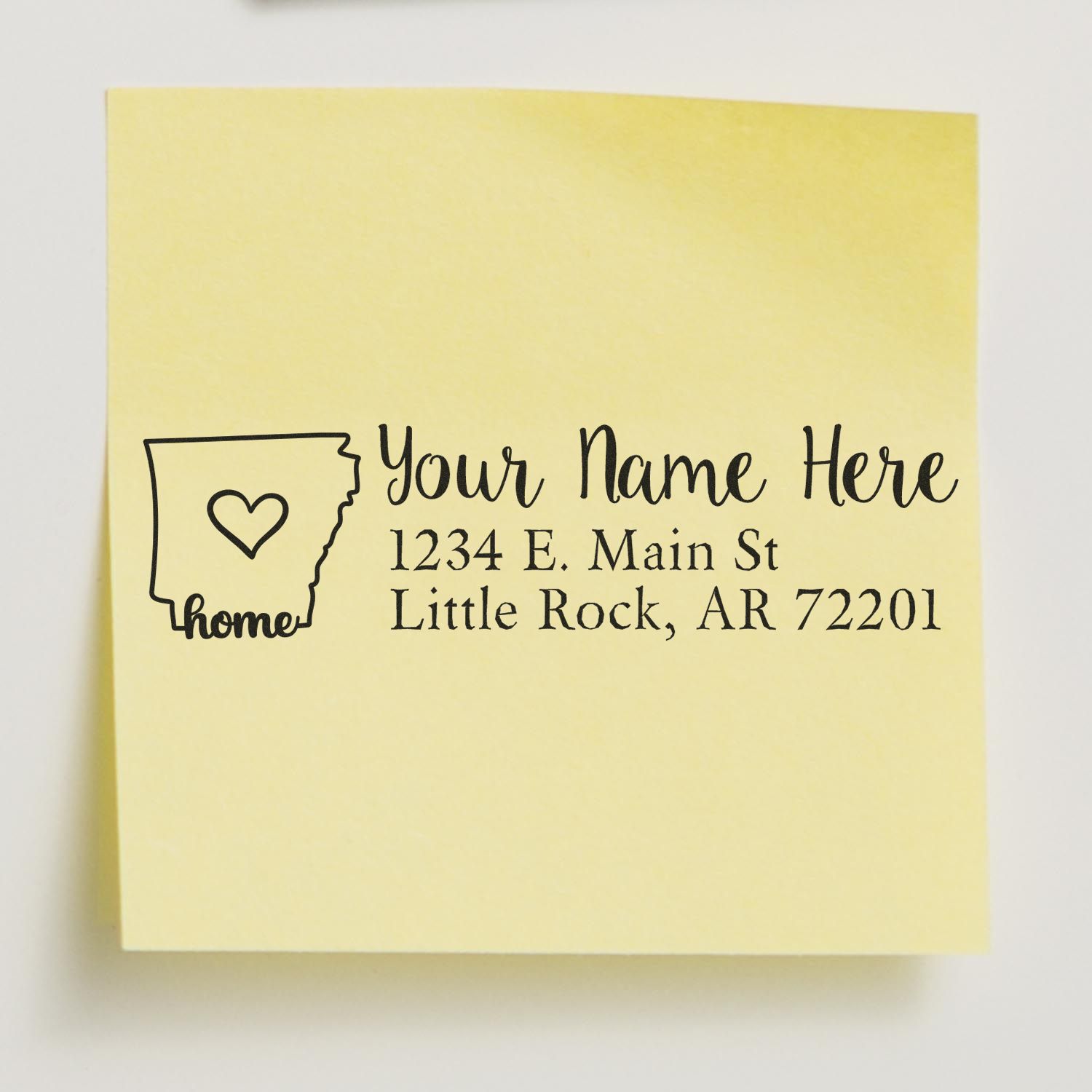 Arkansas state rubber address stamp with wood handle from ESS, showing the custom return address design in use.