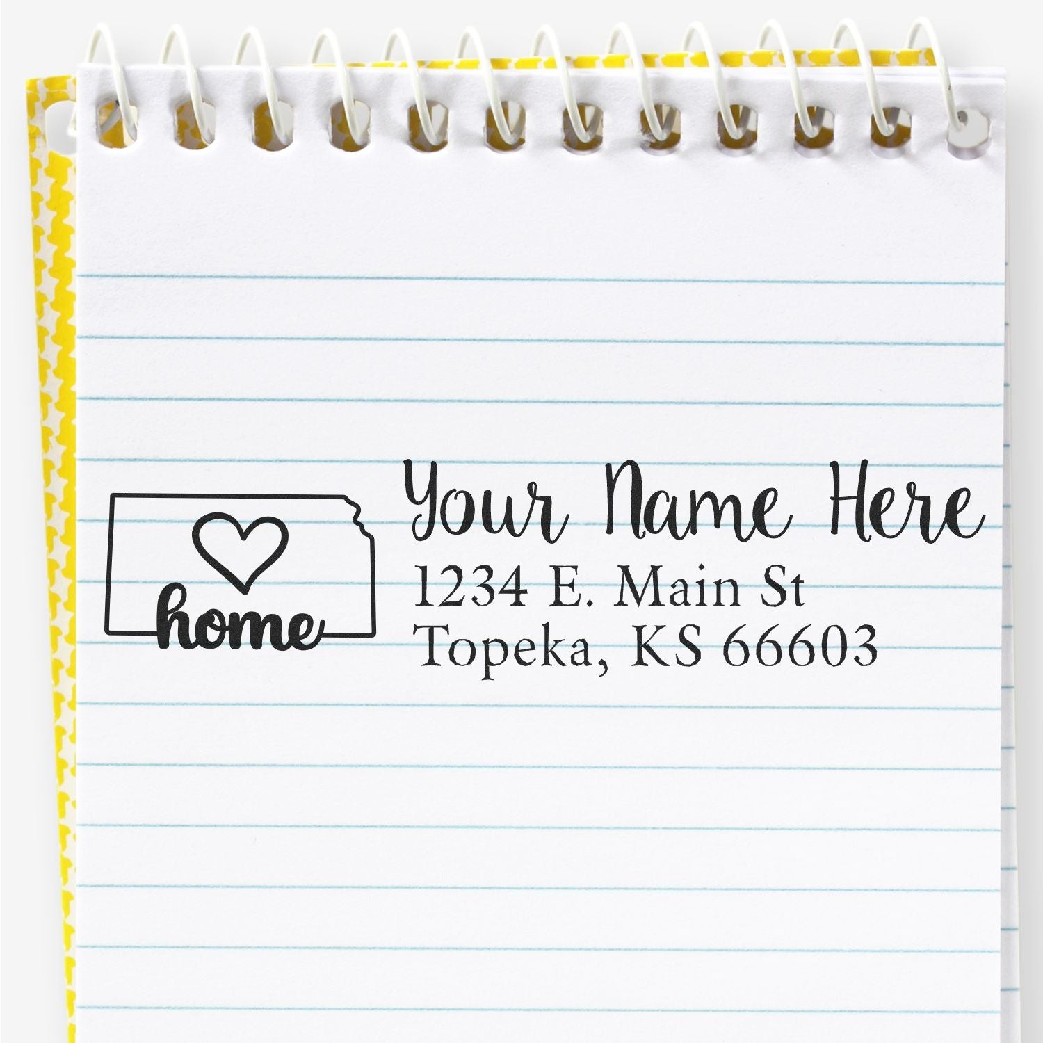 Slim Pre-Inked Kansas State Love Custom Address Stamp on a notepad, featuring a heart design and sample address: Your Name Here, 1234 E. Main St, Topeka, KS 66603.