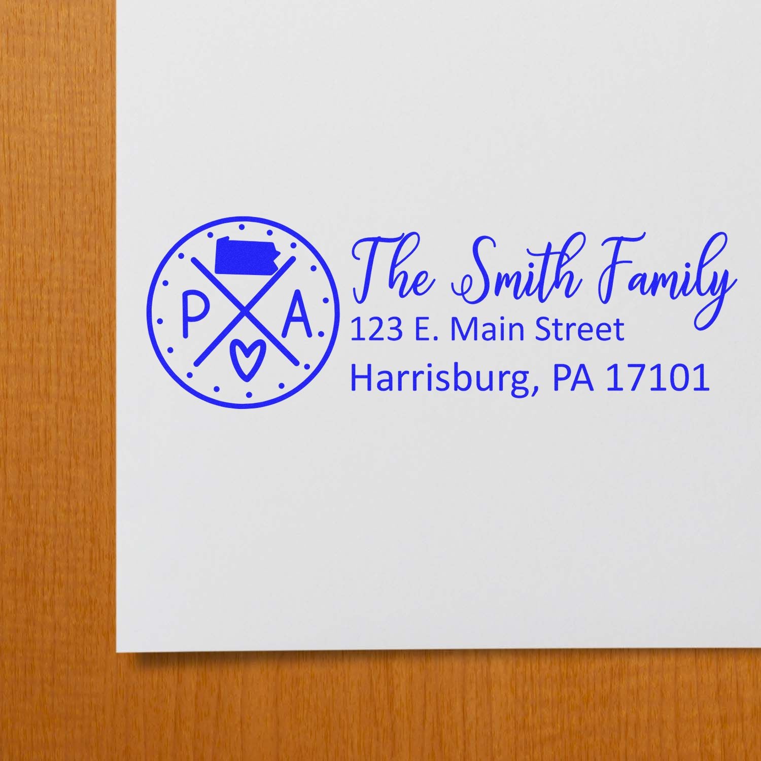Self-Inking State Love of Pennsylvania Custom Address Stamp on white paper, featuring a blue design with PA and a heart, alongside a sample address for the Smith Family in Harrisburg, PA.