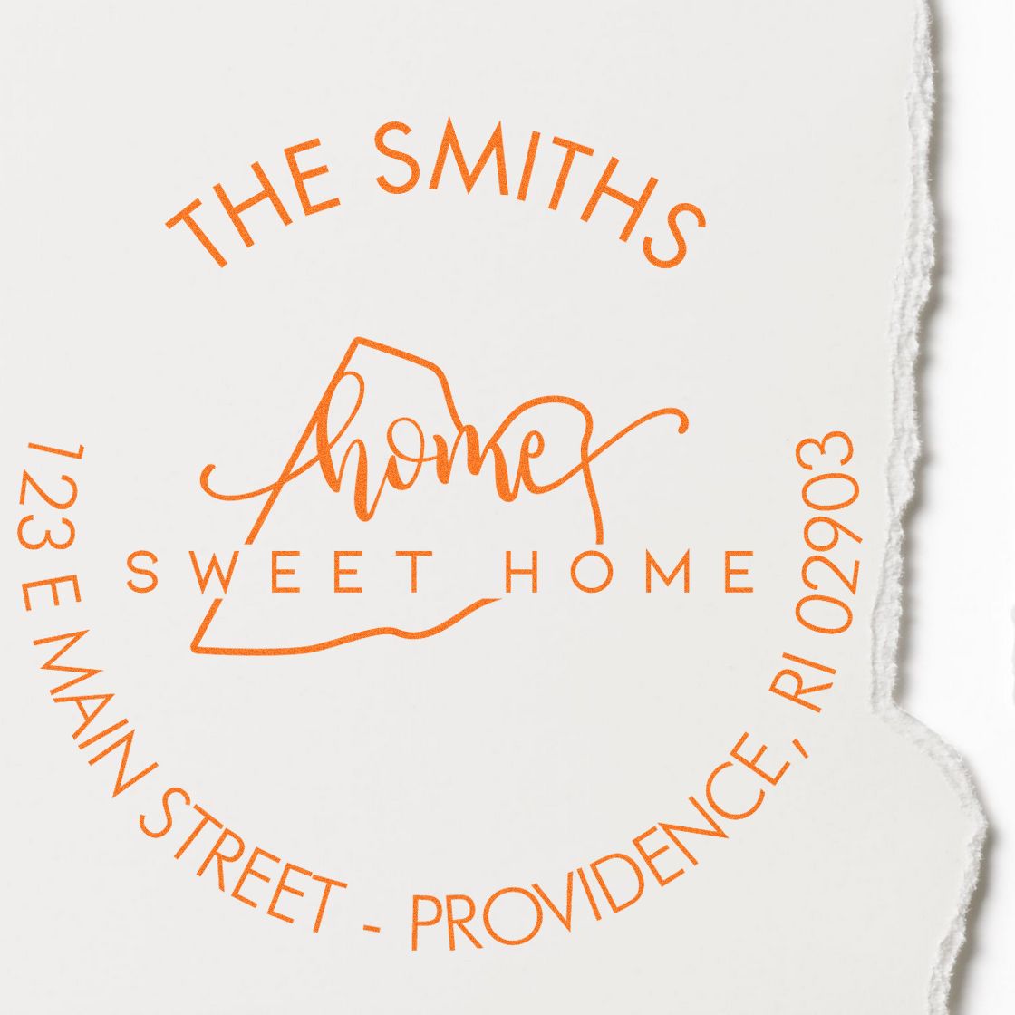 Orange custom address stamp seal with The Smiths Home Sweet Home and Providence, RI address on white paper.
