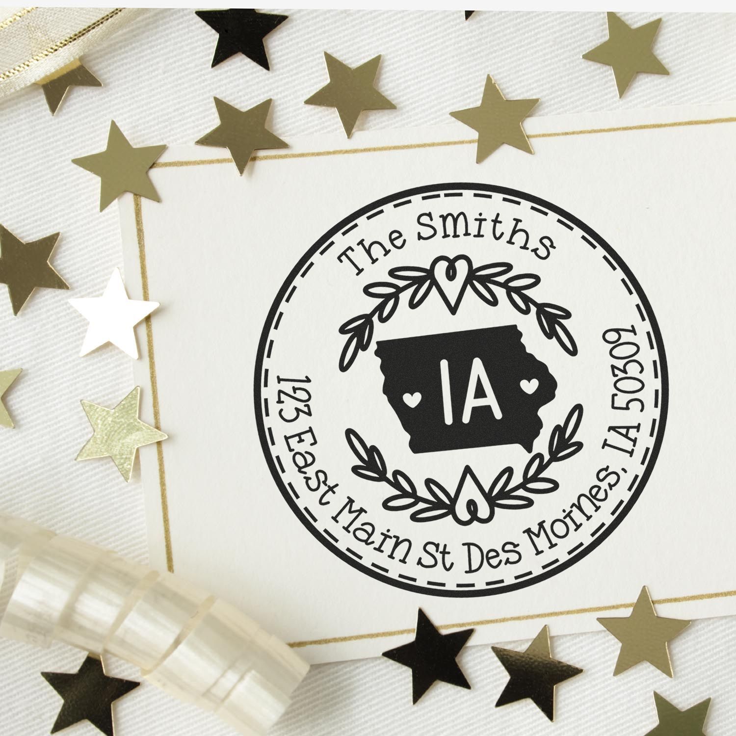 Black custom round stamp seal for The Smiths, with Iowa emblem and address, on a white card with gold and black stars.