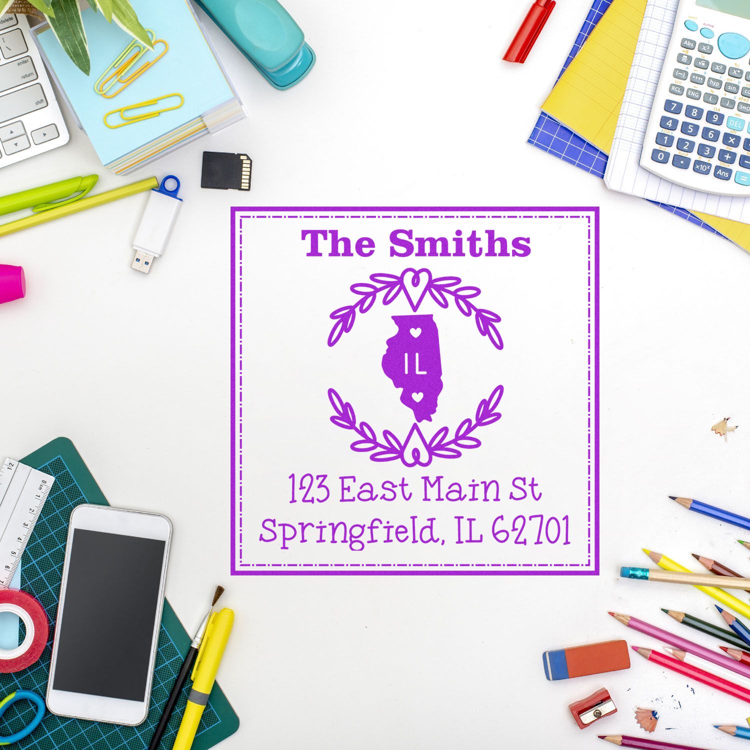 Purple custom stamp and seal for The Smiths, featuring Illinois outline and floral wreath on a white desk with stationery.