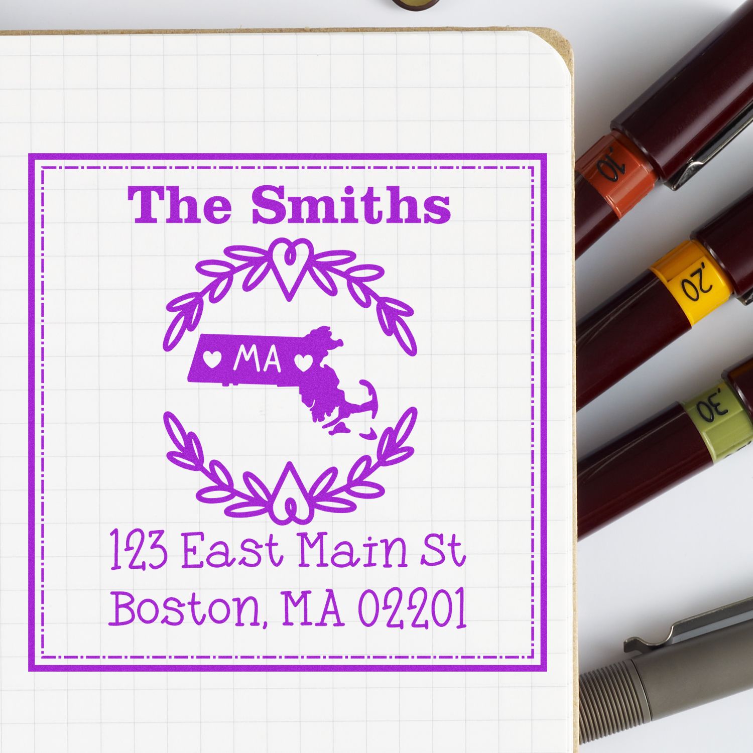 Purple custom stamp and seal with Massachusetts emblem, The Smiths, Boston address, and colored marker caps.