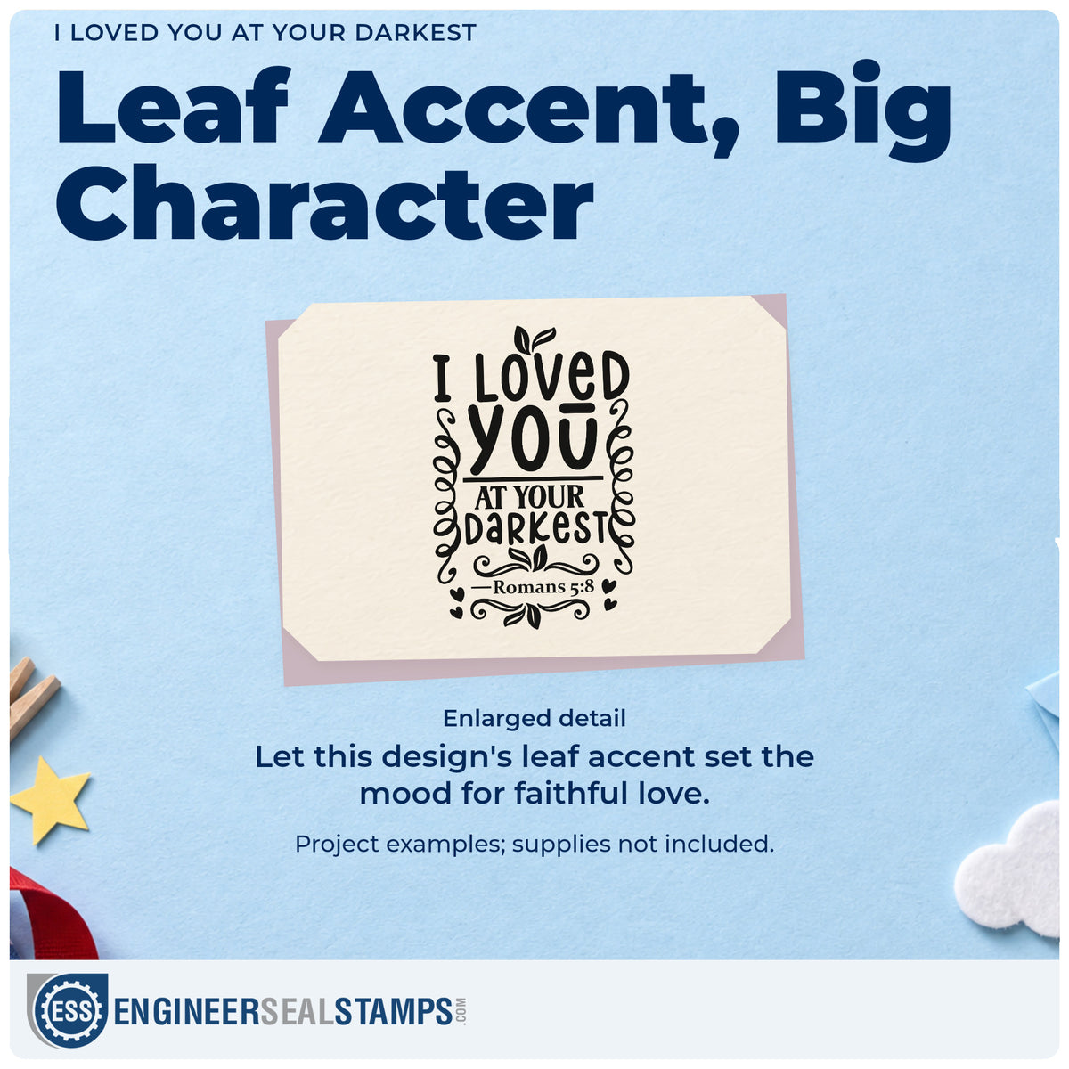 Enlarged detail of the I Loved You At Your Darkest Leaf Accents Wood Handle Stamp imprint. Leafy flourishes and hearts accent "I loved you at your darkest," with Romans 5:8.