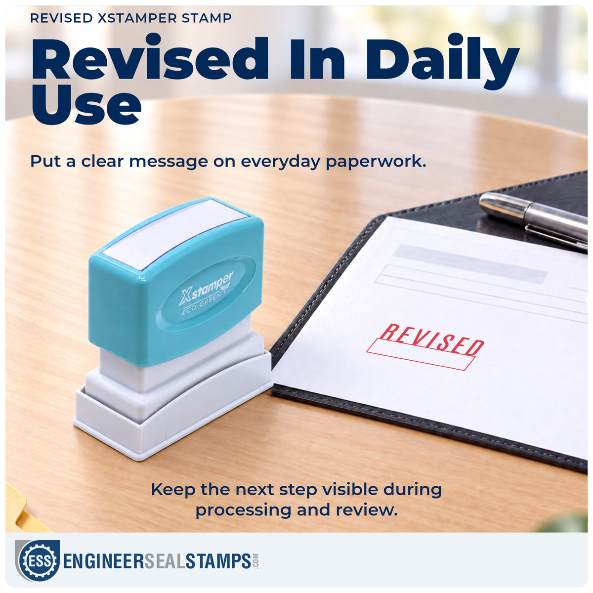 "Revised" stamp being pressed onto a document during everyday filing