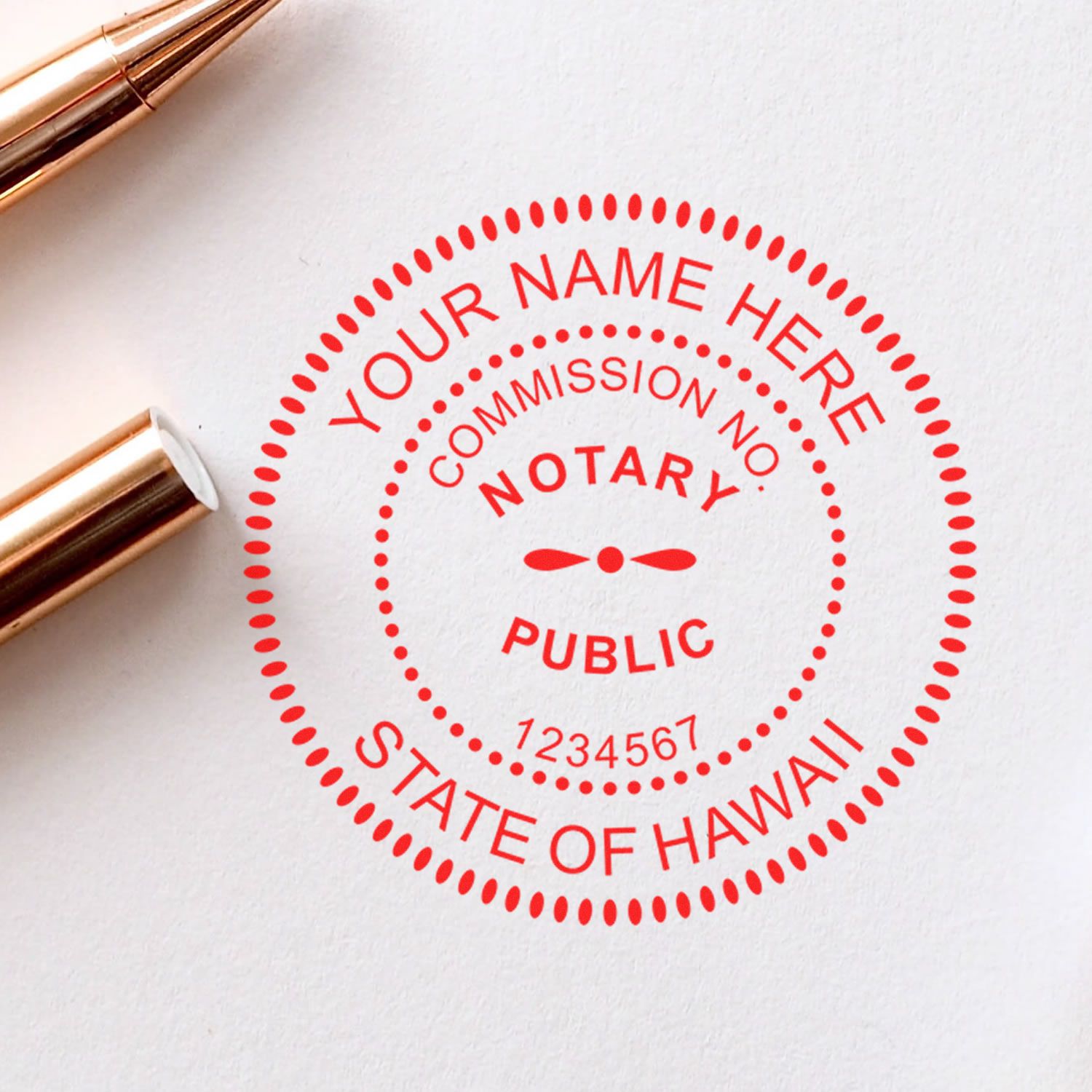 Red notary public seal stamp with State of Hawaii text on white paper, gold stamp handles