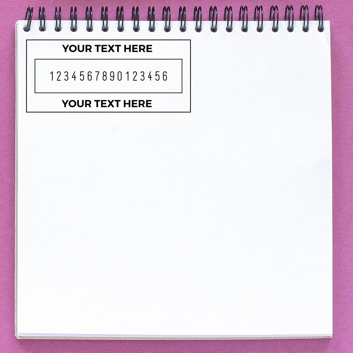 Black custom stamp and seal template on white spiral notepad, with text placeholders and numbers on a pink background.