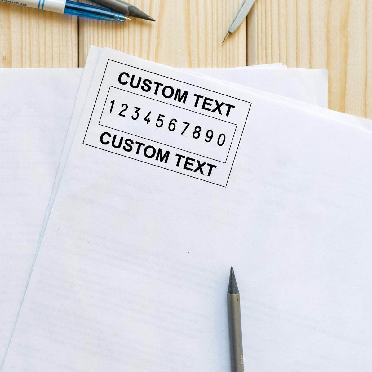 Custom stamp and seal layout on white paper, black text and numbers, on a light wood desk with pens.