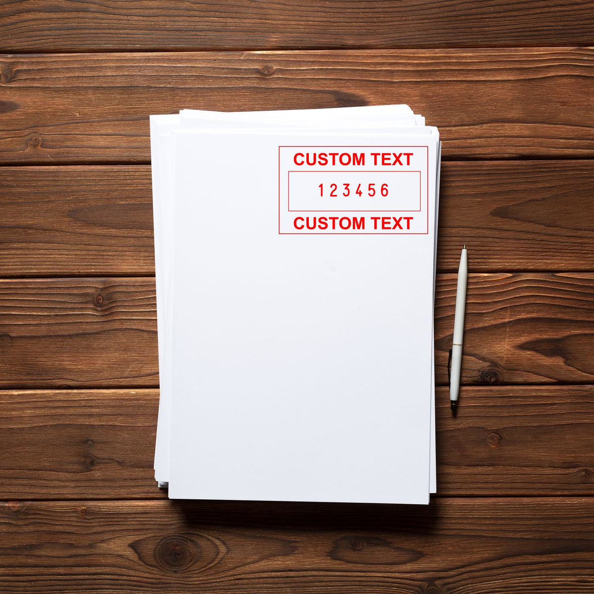 Stack of white papers with red custom text stamp seal and pen on rustic brown wood background.