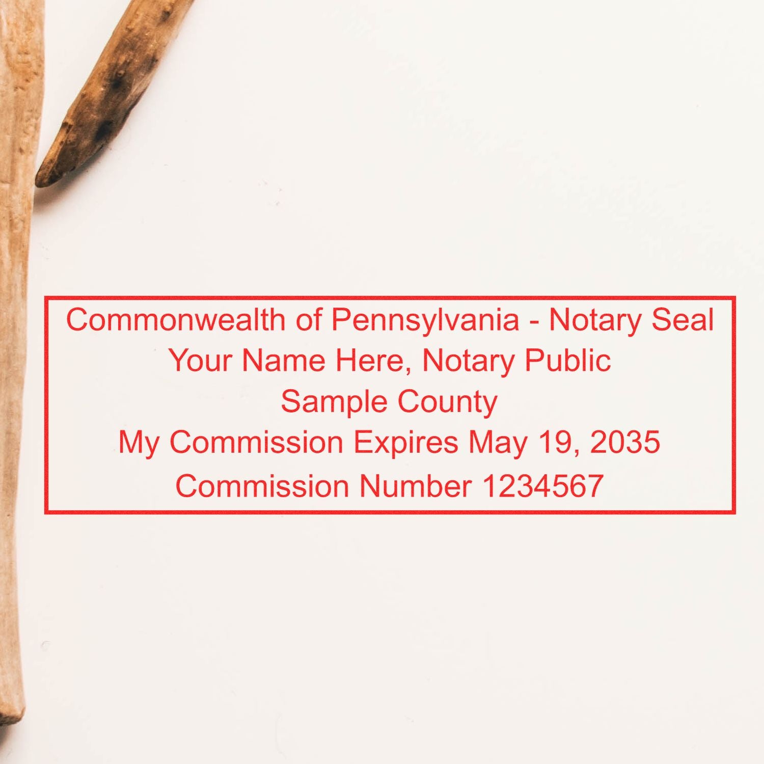 Red Pennsylvania notary seal stamp with commission details in a rectangular border on a white background.