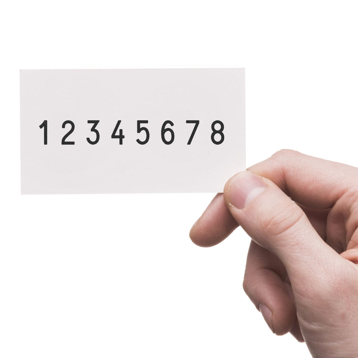 Hand holding a white stamp sample card with black numbers 18, showing a clean seal product display.