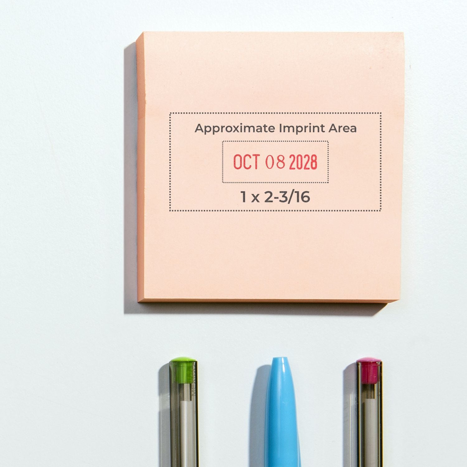 Peach self-inking date stamp and seal block with red OCT 08 2028 imprint area, plus green, blue, and pink stamp pens below.