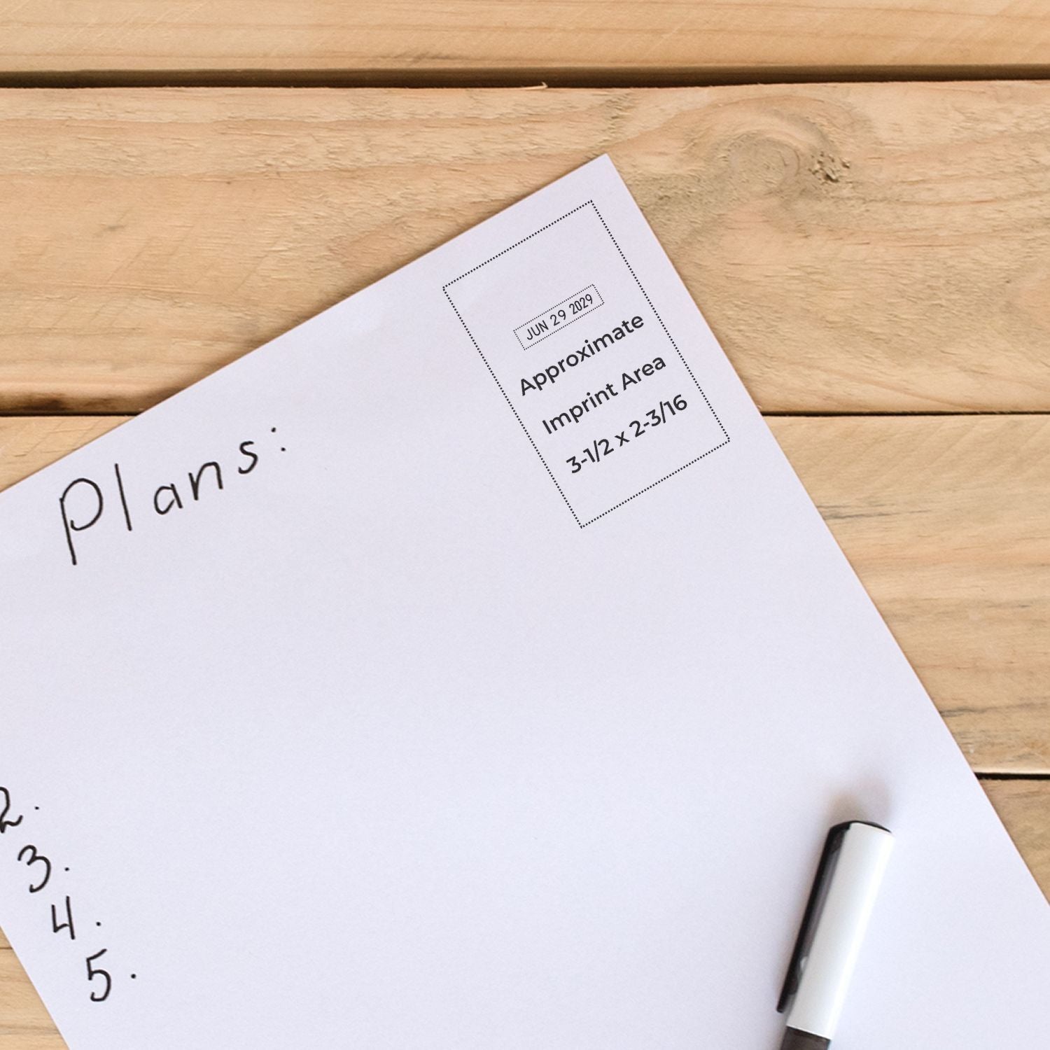 White stamp proof sheet on wood, with dotted imprint area, handwritten plans, and a black-and-white seal sample.