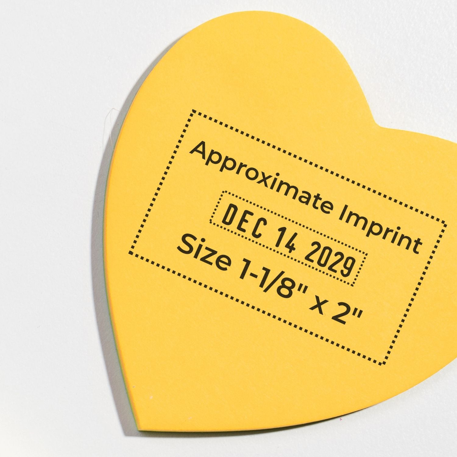 Yellow heart-shaped stamp seal with black dotted border, Approximate Imprint, Dec 14 2029, size 1-1/8 x 2 inches