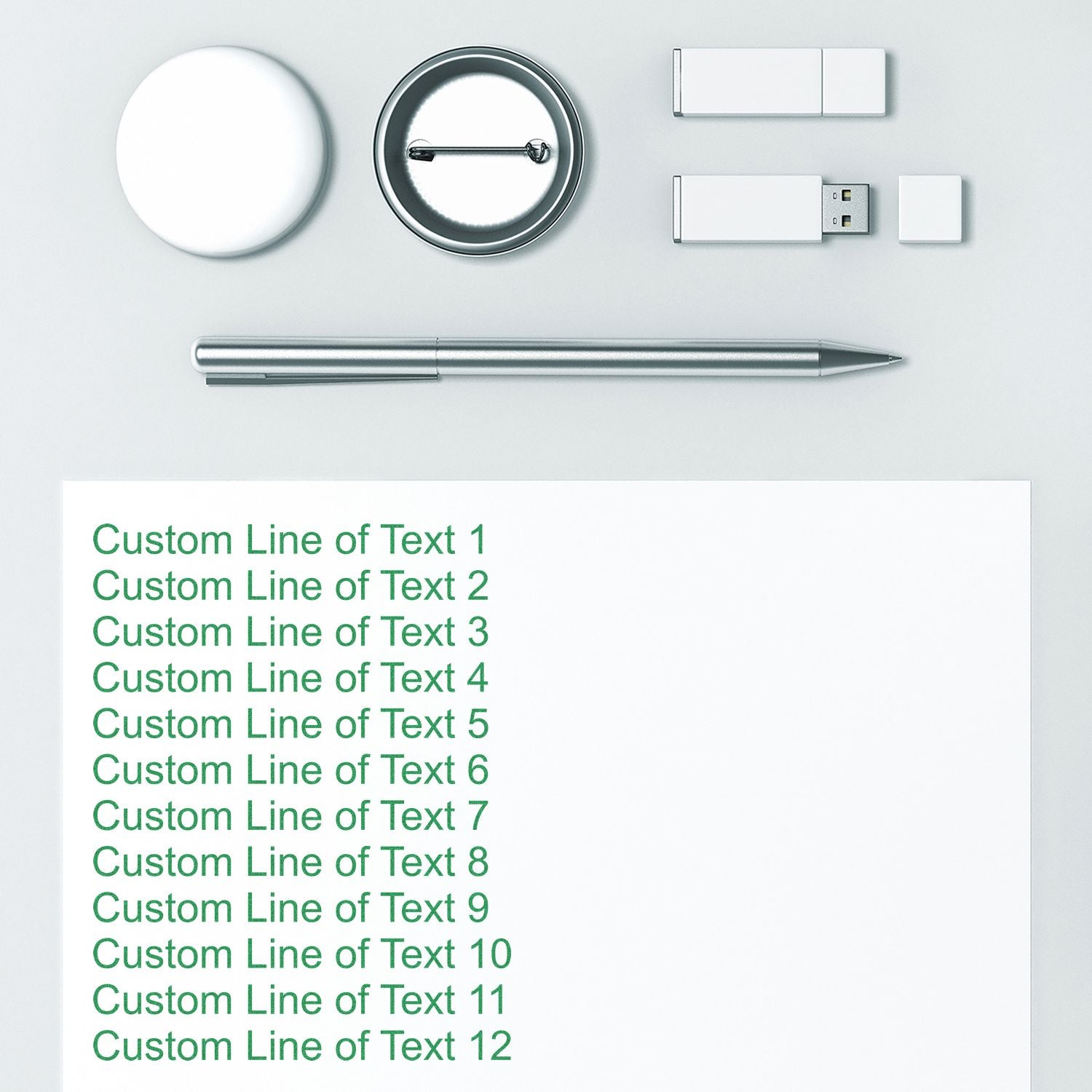 12 Line Custom Rubber Stamp with Wood Handle used to stamp green text on white paper, surrounded by office supplies like a pen and USB drives.