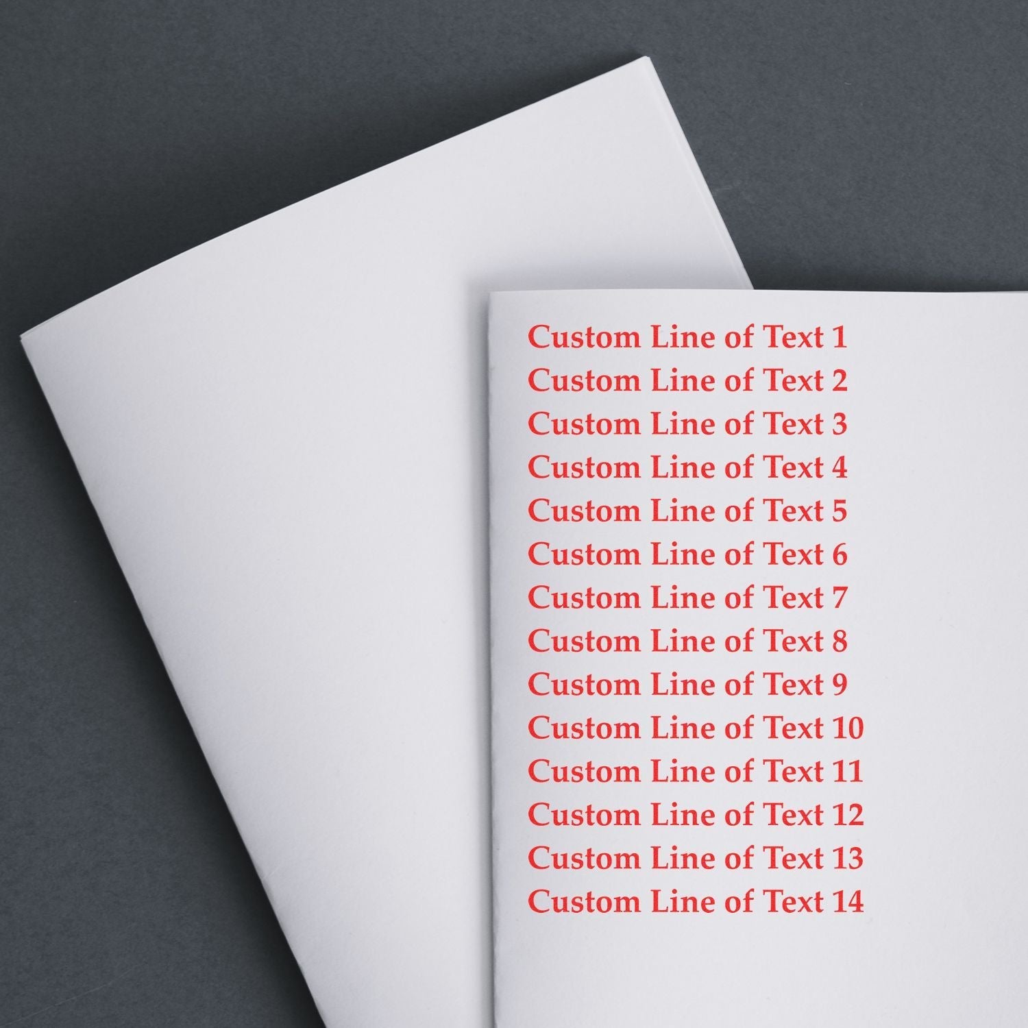 14 Line Custom Rubber Stamp with Wood Handle in use, stamping red text on white paper with 14 lines of customizable text.