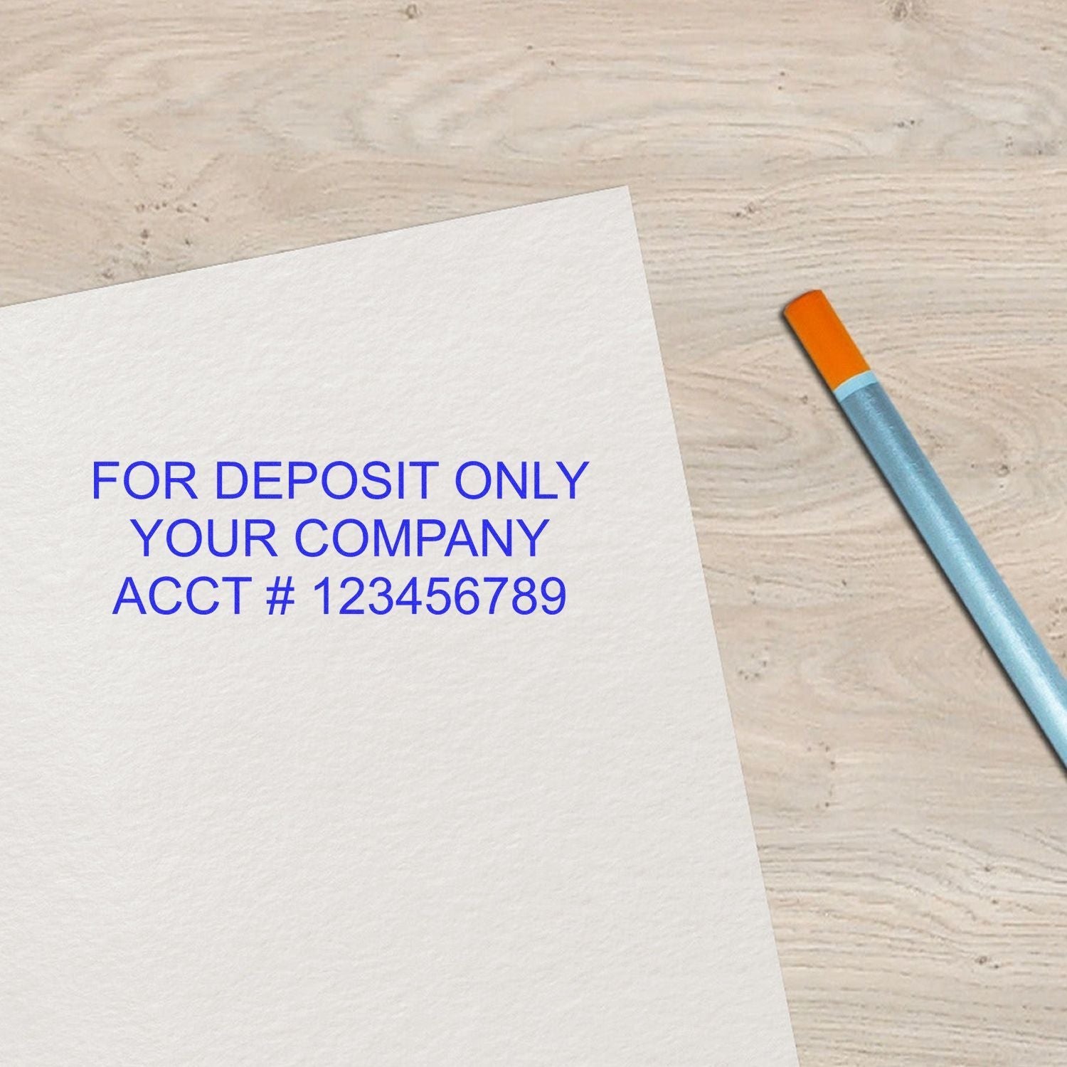 3 Line Wood Handle Custom Rubber Check Endorsement Stamp in use, stamping FOR DEPOSIT ONLY YOUR COMPANY ACCT # 123456789 on white paper.