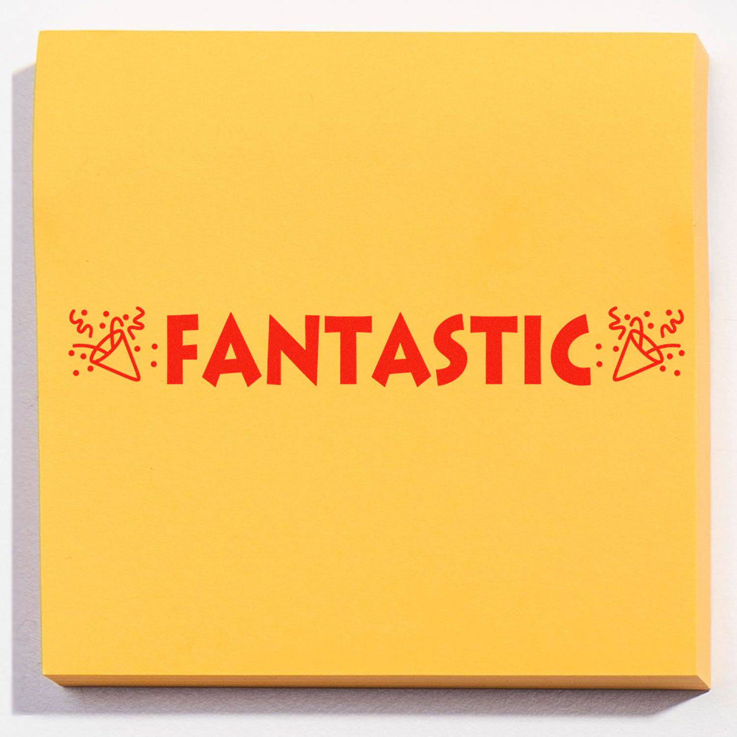 Large Pre-Inked Fantastic with Icons Stamp on a yellow sticky note, featuring the word FANTASTIC in red with celebratory icons.