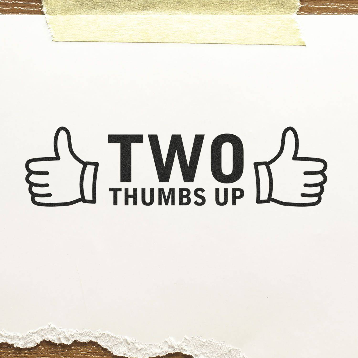 Image of the Large Pre-Inked Two Thumbs Up with Thumb Icon Stamp imprint on white paper, showing two thumbs up icons and the text TWO THUMBS UP.