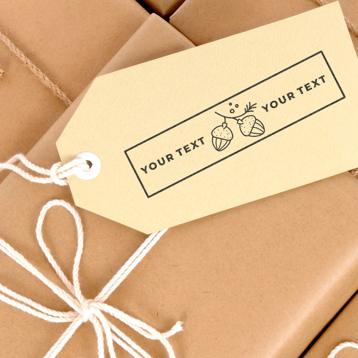 Gift tag stamped with Slim Stamp 1854 Customized Pre-Inked Stamp 11/16 x 2-1/8, featuring acorn design and Your Text placeholder, tied to a package.
