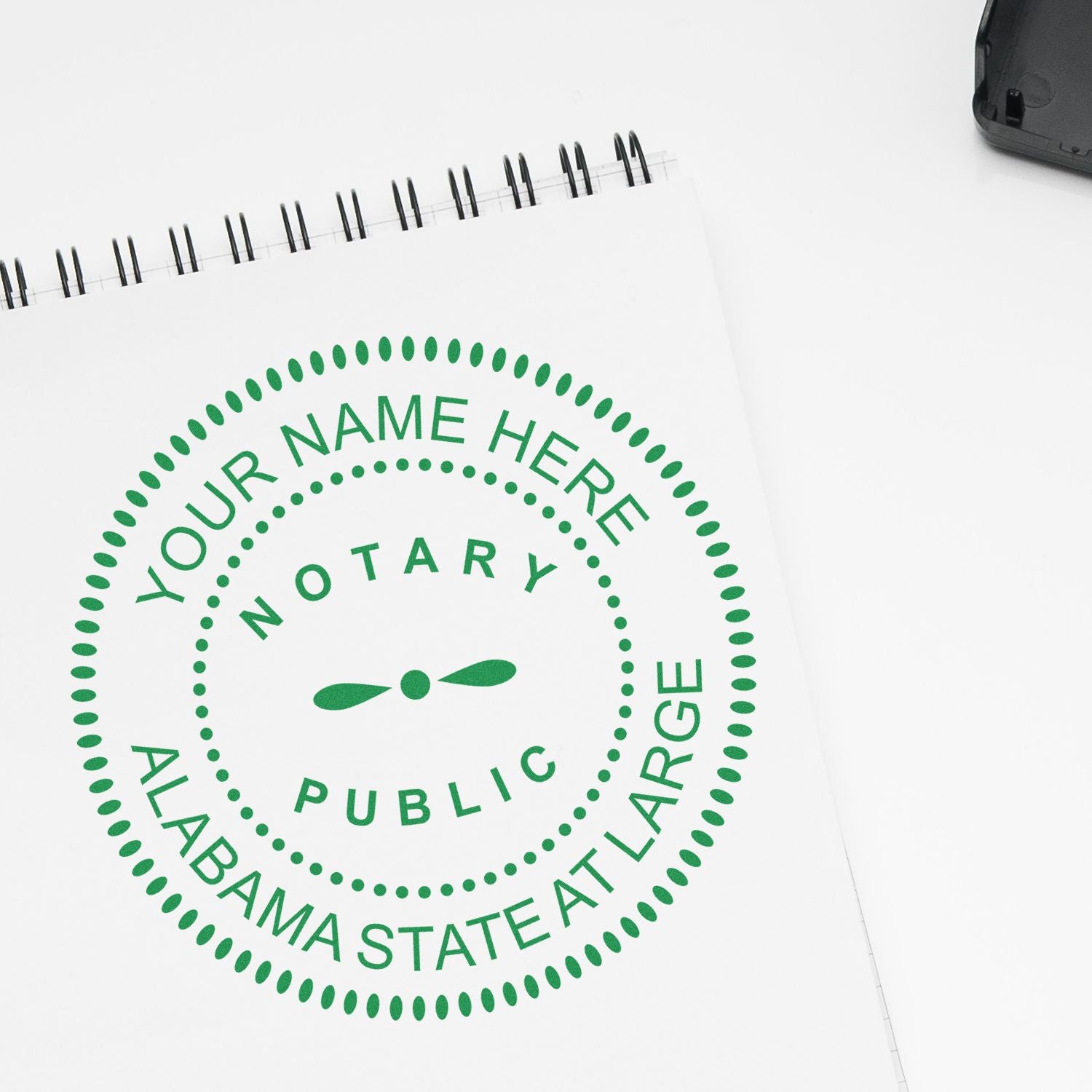 A lifestyle photo showing a stamped image of the Premium Pre-Inked Alabama MaxLight Notary Public Stamp on a piece of paper