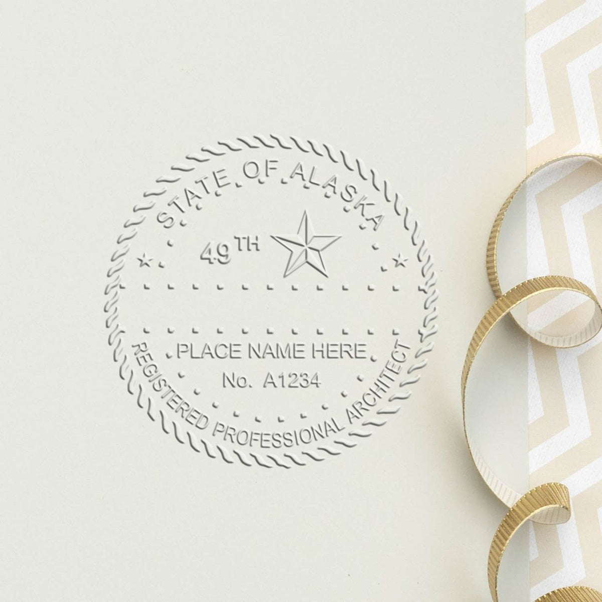 A lifestyle photo showing a stamped image of the Handheld Alaska Architect Seal Embosser on a piece of paper