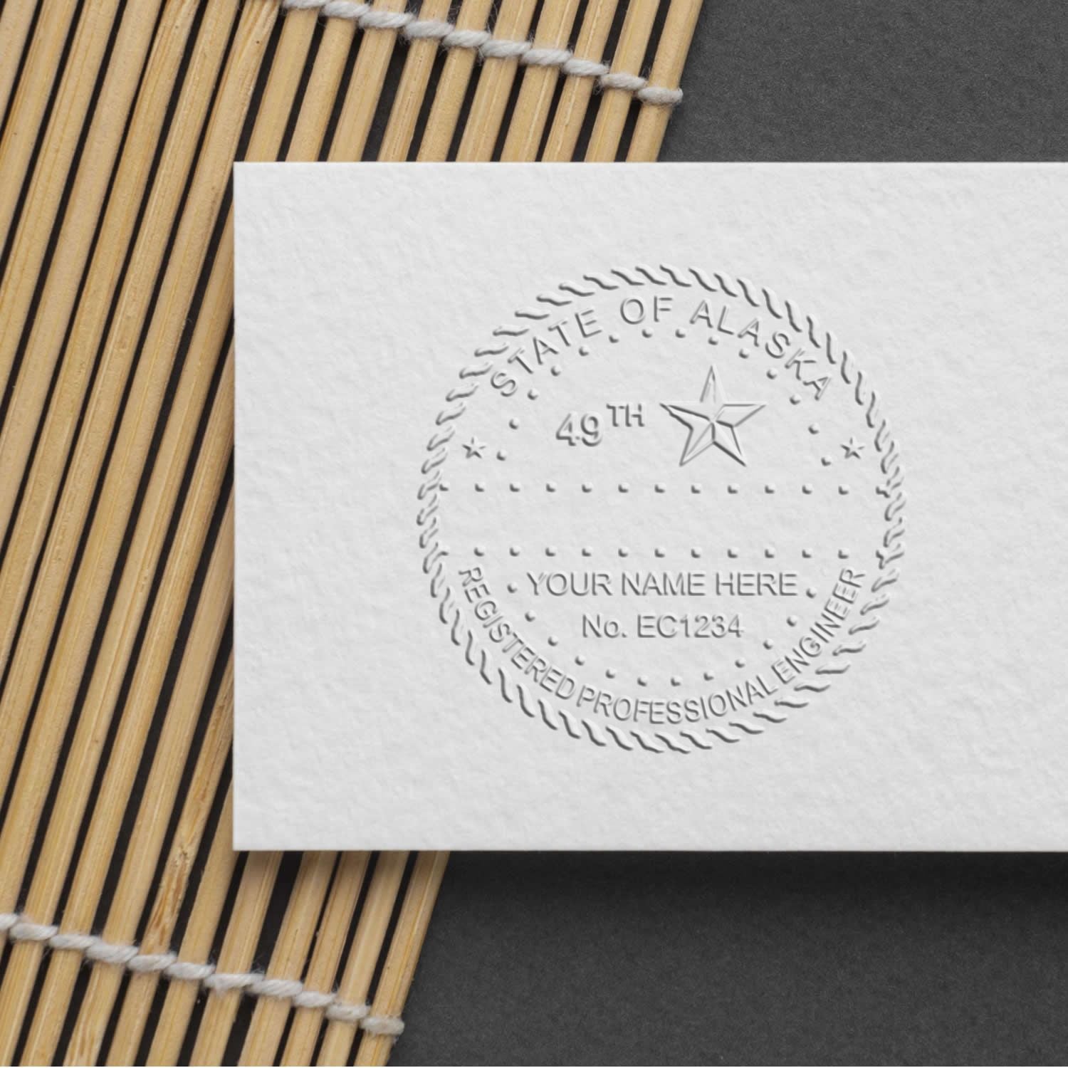 A stamped impression of the State of Alaska Extended Long Reach Engineer Seal in this stylish lifestyle photo, setting the tone for a unique and personalized product.