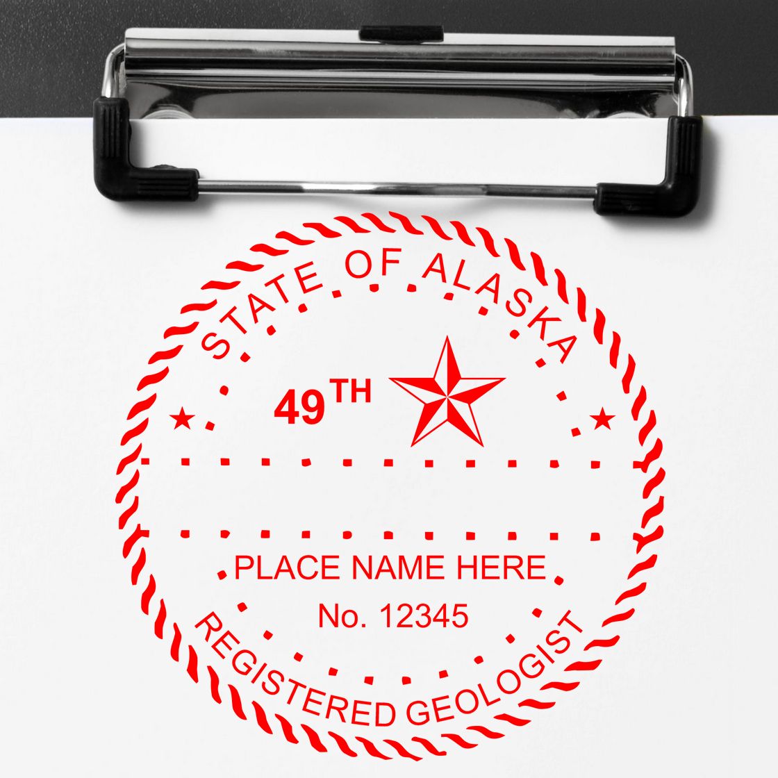 An in use photo of the Premium MaxLight Pre-Inked Alaska Geology Stamp showing a sample imprint on a cardstock