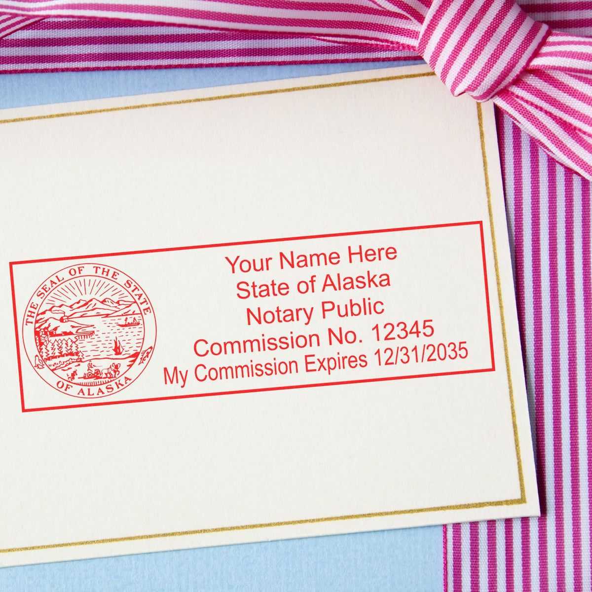 An alternative view of the Slim Pre-Inked State Seal Notary Stamp for Alaska stamped on a sheet of paper showing the image in use