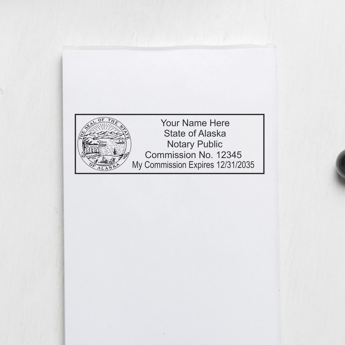 The Slim Pre-Inked State Seal Notary Stamp for Alaska stamp impression comes to life with a crisp, detailed photo on paper - showcasing true professional quality.
