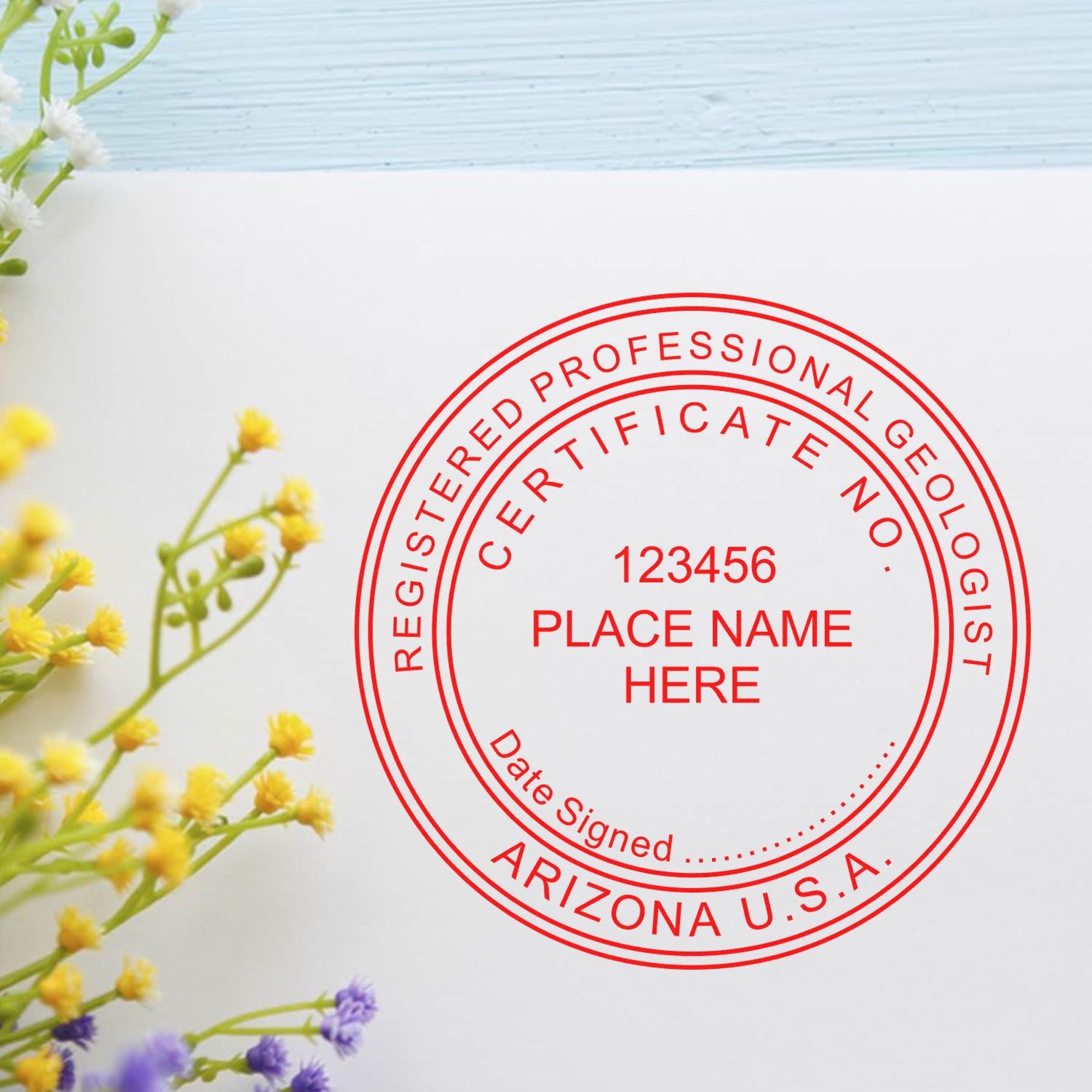 An in use photo of the Arizona Professional Geologist Seal Stamp showing a sample imprint on a cardstock