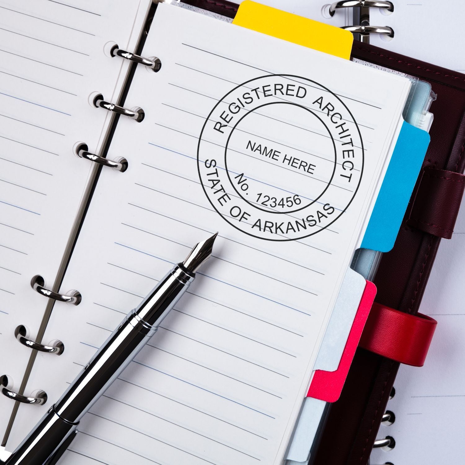 Premium MaxLight Pre-Inked Arkansas Architectural Stamp used on a notebook page with a pen beside it.