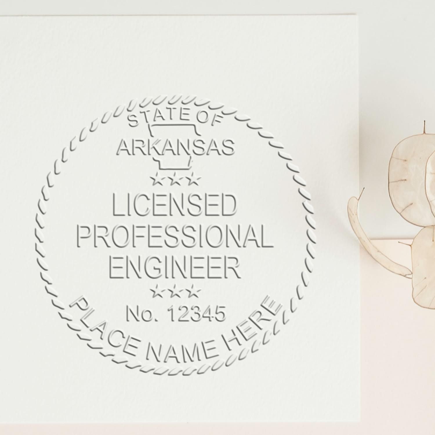 Arkansas Engineer Desk Seal by Trodat, state engineer embossing seal with Arkansas emblem on a wooden desk.