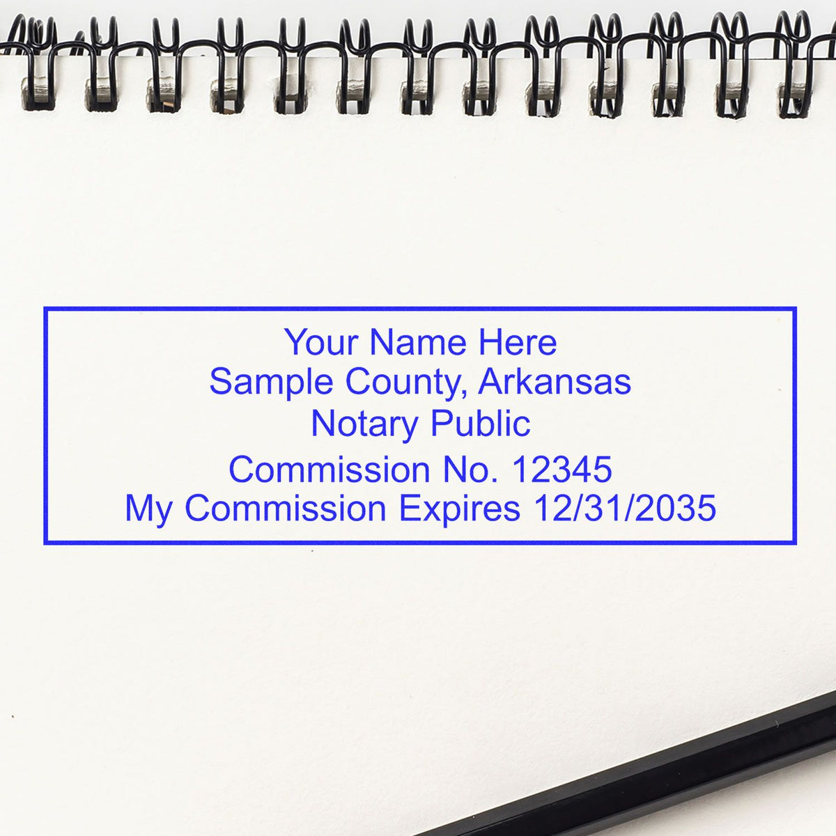 An alternative view of the Slim Pre-Inked Rectangular Notary Stamp for Arkansas stamped on a sheet of paper showing the image in use