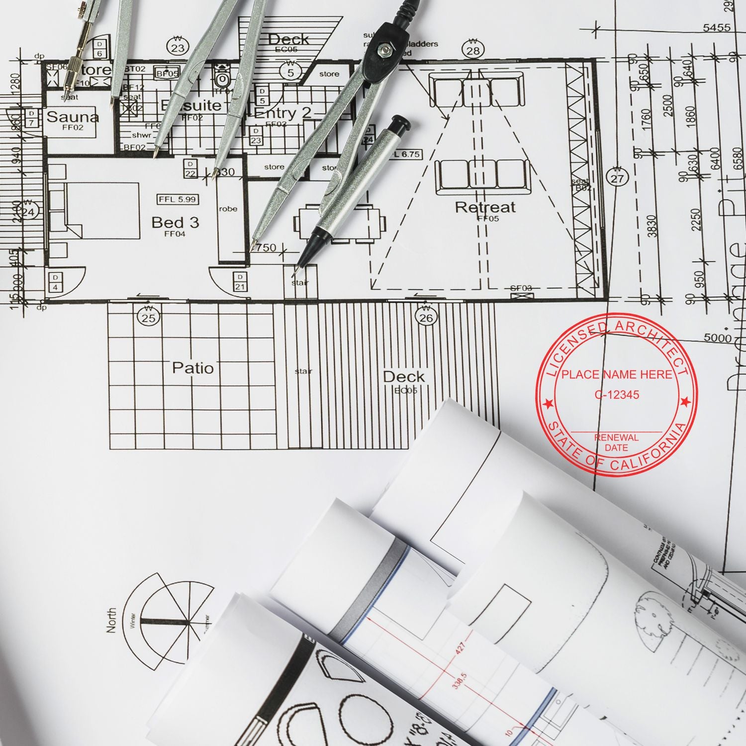 Architectural blueprint with a Self Inking California Architect Stamp, compass, and drafting tools on a desk.