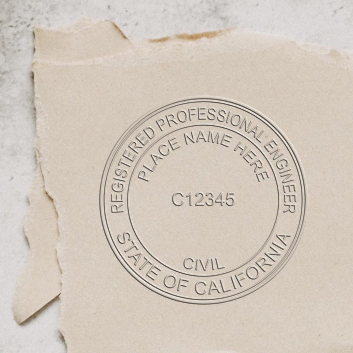 A lifestyle photo showing a stamped image of the Handheld California Professional Engineer Embosser on a piece of paper