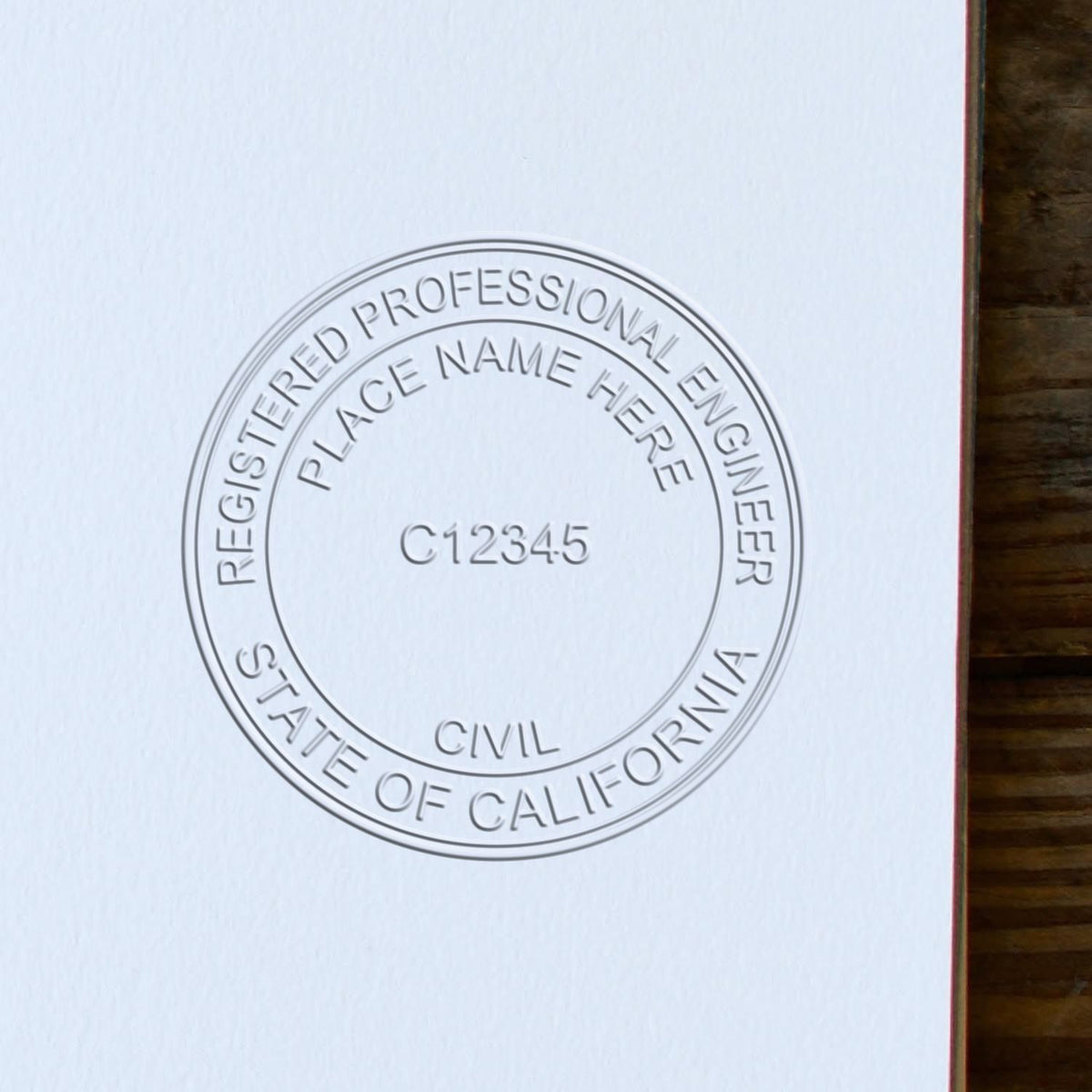An alternative view of the Heavy Duty Cast Iron California Engineer Seal Embosser stamped on a sheet of paper showing the image in use