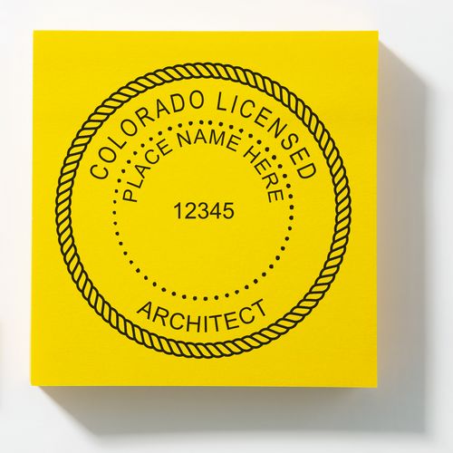 A lifestyle photo showing a stamped image of the Slim Pre-Inked Colorado Architect Seal Stamp on a piece of paper