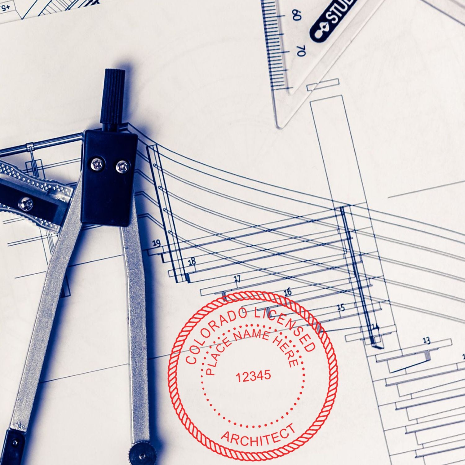 Self Inking Colorado Architect Stamp on architectural blueprints with drafting tools in the background.